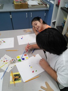 First Grade Students mix primary colors to make secondary colors.